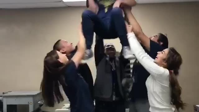 Group of girls lift friend in chair and head hits ceiling