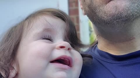 Baby amused by drinking dad