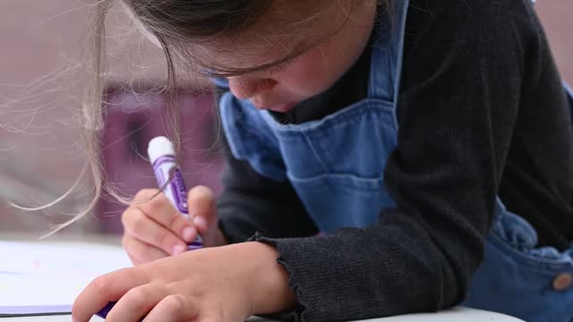 Little Girl Drawing with Color Marker