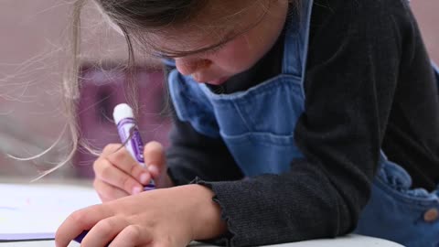 Little Girl Drawing with Color Marker