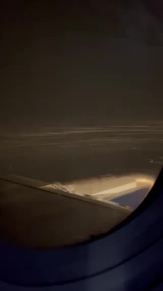 Look here! Snowing outside, plane landing.