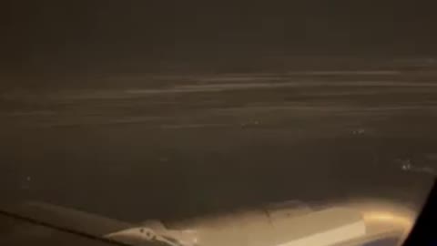 Look here! Snowing outside, plane landing.
