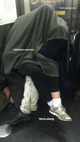 Nothing to see here two people fool around under blanket