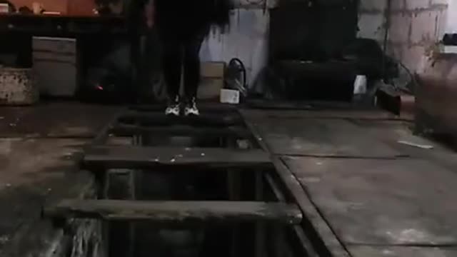 Man Jumping on Wooden Boards Unexpectedly Falls