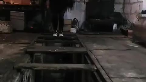 Man Jumping on Wooden Boards Unexpectedly Falls