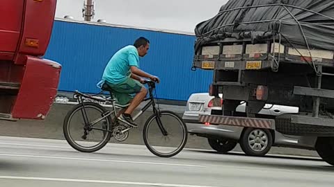 Bicycle Catches a Ride Behind Truck