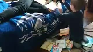 The baby threw books at his brother while he slept