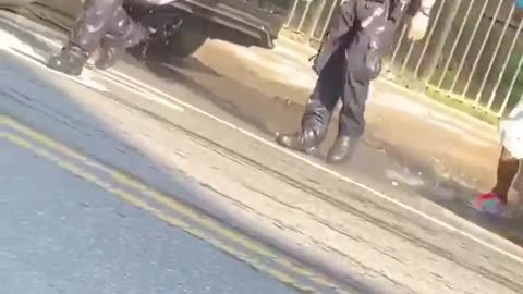 Police Walk Away After Getting Drenched