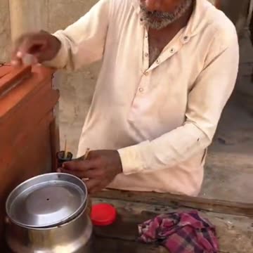 Desi man making desi kulfi