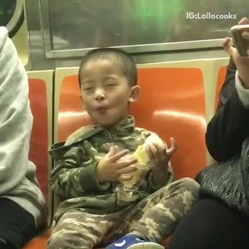 Little boy subway army outfit enjoying food
