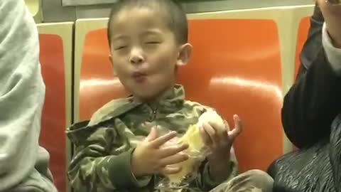 Little boy subway army outfit enjoying food