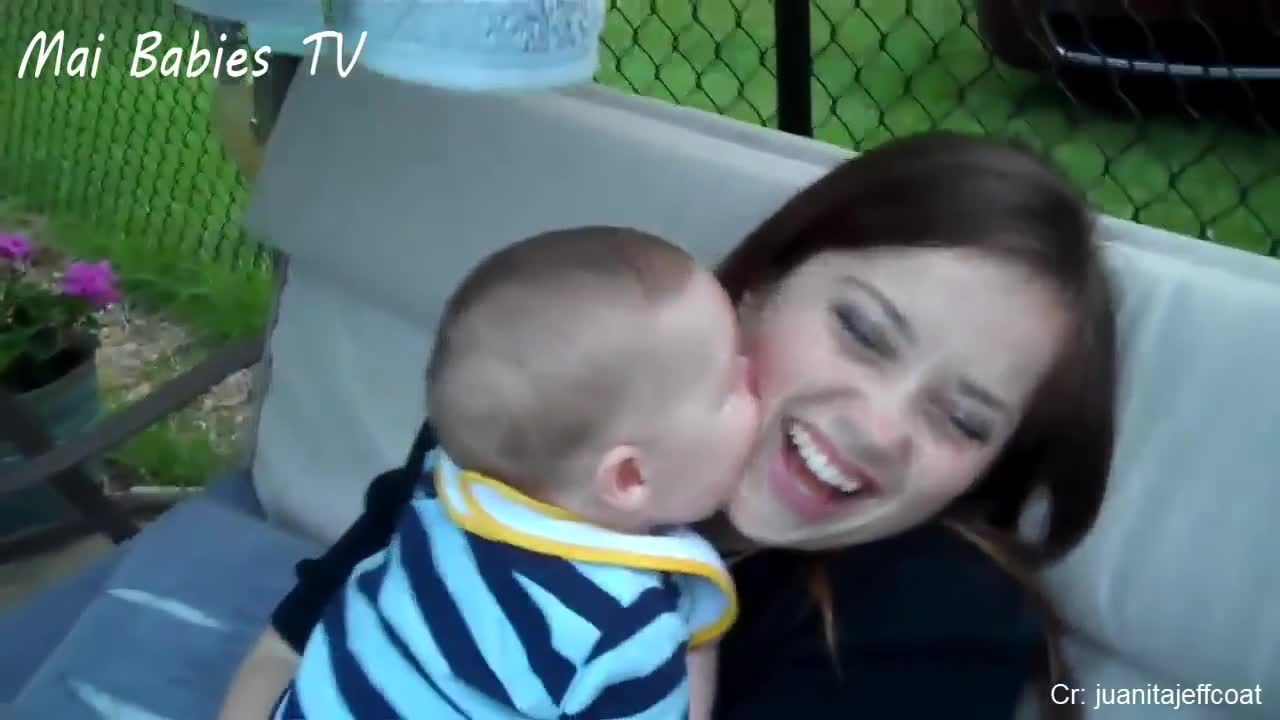 cute baby kissing mom, funny interaction mom with baby