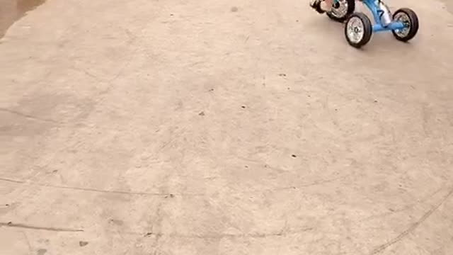 Cute baby learning to ride a bike