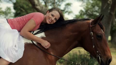 girl laying on her horse