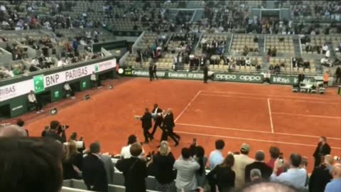 A climate extremist ran into the court at the French Open and tied herself to the net.