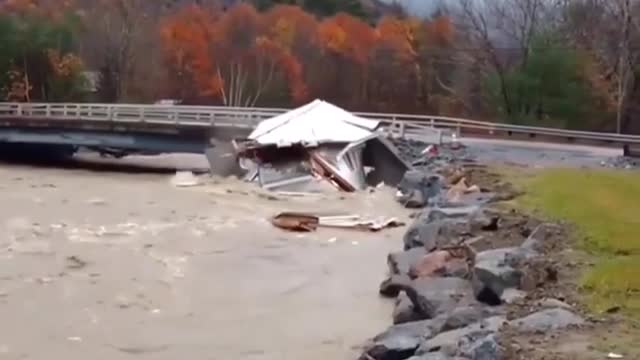 House being swept away in the river gets torn to shreads by a bridge