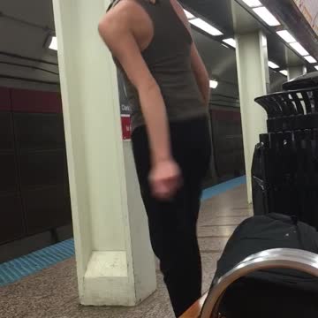 Guy blonde short hair grey tank top dancing subway platform