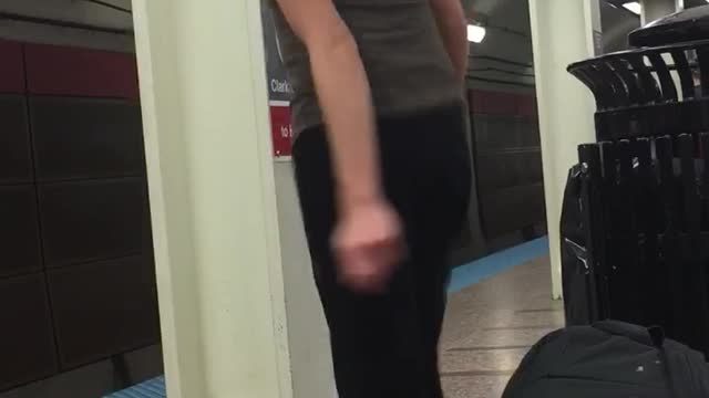 Guy blonde short hair grey tank top dancing subway platform