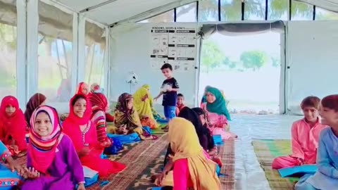 3 years baby distributing sweets among the students