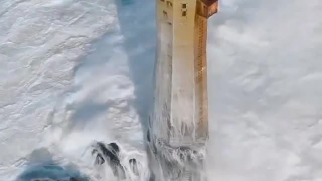 A FRENCH LIGHTHOUSE GETTING PUMMELED BY WAVES