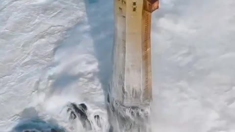 A FRENCH LIGHTHOUSE GETTING PUMMELED BY WAVES