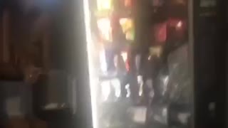 girl takes an ice bucket and breaks opens a vending machine