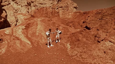 A man helping a woman walk downhill