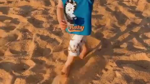 Baby's on the sand for the first time