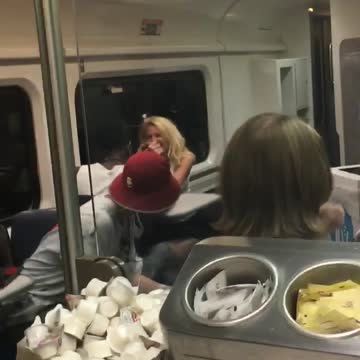 Two people arm wrestle in subway
