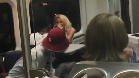 Two people arm wrestle in subway