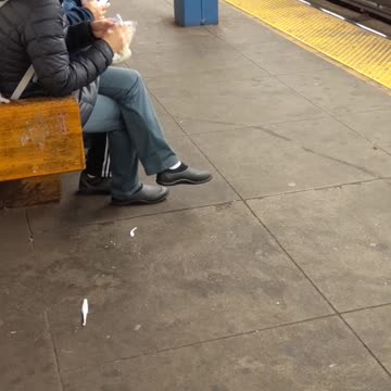 Woman in black jacket eating popcorn