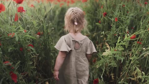 Girl Walking Between Flowers