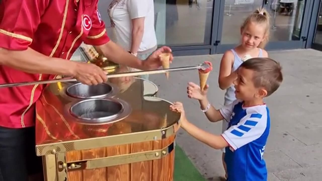 Ice Cream Vendor Plays Game With Young Customer