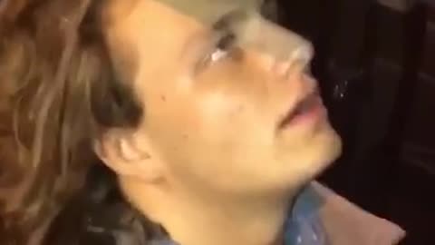 Guy in grey inside car throwing up in bucket
