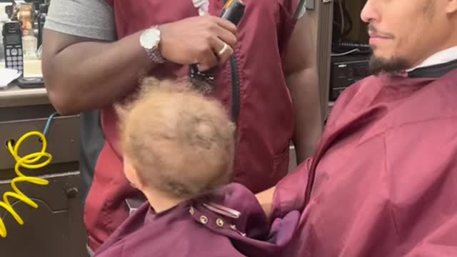 Baby getting a first hair cut