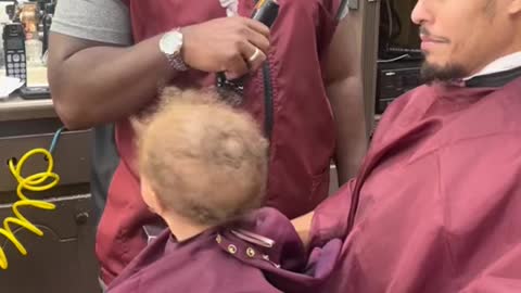 Baby getting a first hair cut