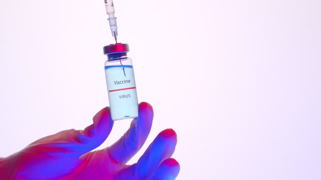 Person Holding a Vaccine Vial