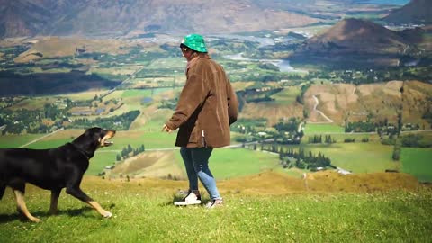 Woman playing with a dog 2021.