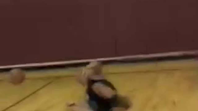 Guy goes for rebound but slips on ground and lands on back