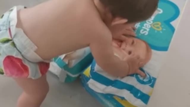 Sweet baby kisses image of another baby on diaper bag👏🏽