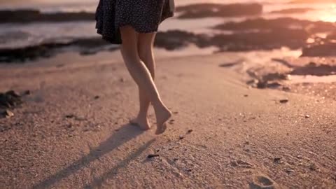 A Woman Walking Barefooted On The Shore | See What happened!