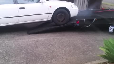 Man Has Trouble Getting Car onto Trailer