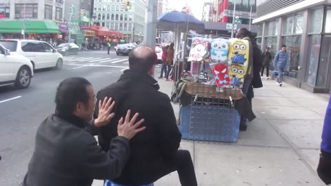 Luodong Massages Bald White Guy On Sidewalk