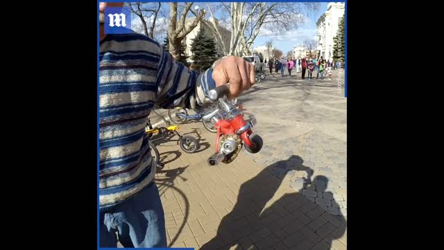 Old man riding the smallest bike