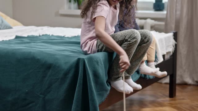 Kids Playing Catch The Bait With Their Cat on the floor