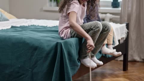 Kids Playing Catch The Bait With Their Cat on the floor