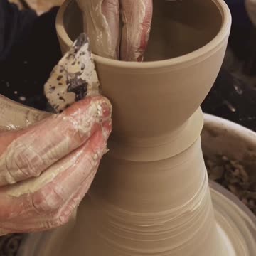 Creating a new clay pot on the potters wheel