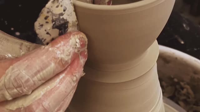 Creating a new clay pot on the potters wheel