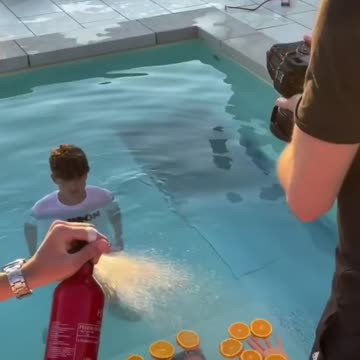 Man takes picture in pool