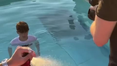 Man takes picture in pool